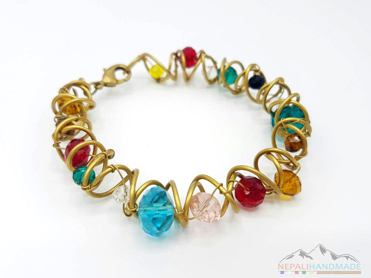 Multicolor faceted beads bracelet with gold-tone wire wrapping and clasp closure.