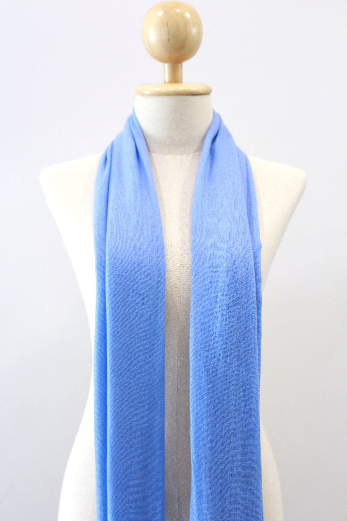 Sky Blue cashmere scarf draped on a mannequin, front view.
