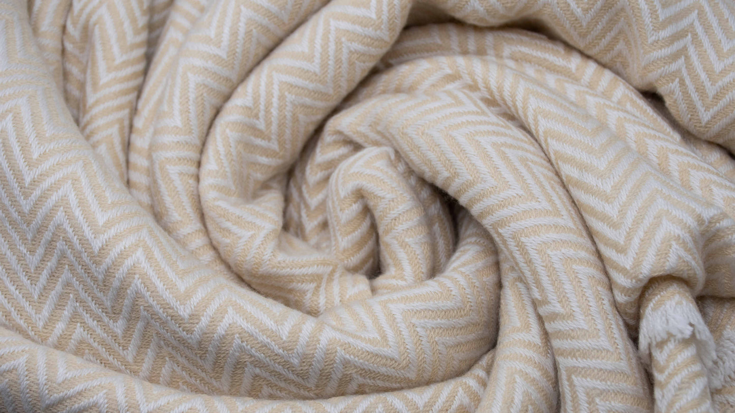Yellow And White Chevron Cashmere Blanket displayed in a swirled style showcasing the knit design and fringe