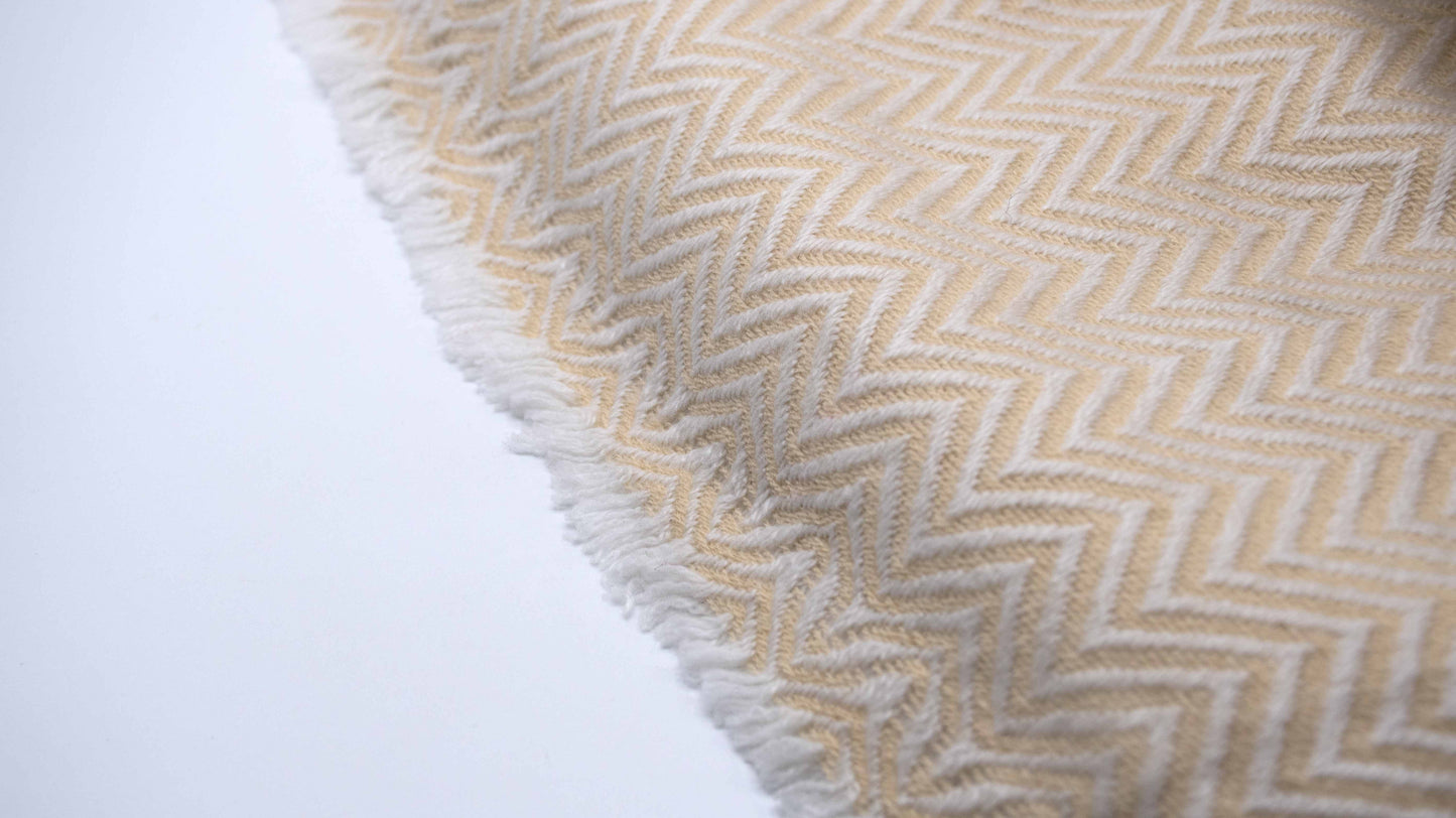 zoomed and close up view of Yellow And White Chevron Cashmere Blanket displaying the knitting details and micro fringes showing the quality of the yarn