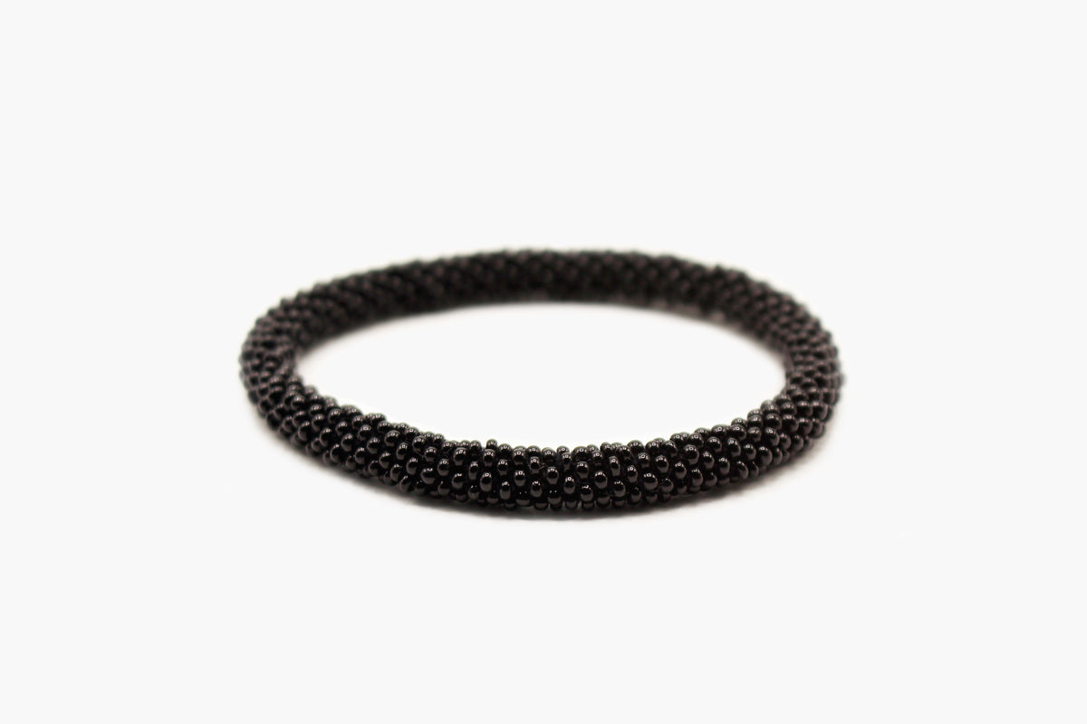 Black glass bead roll-on bracelet with solid glossy beadwork, front view.