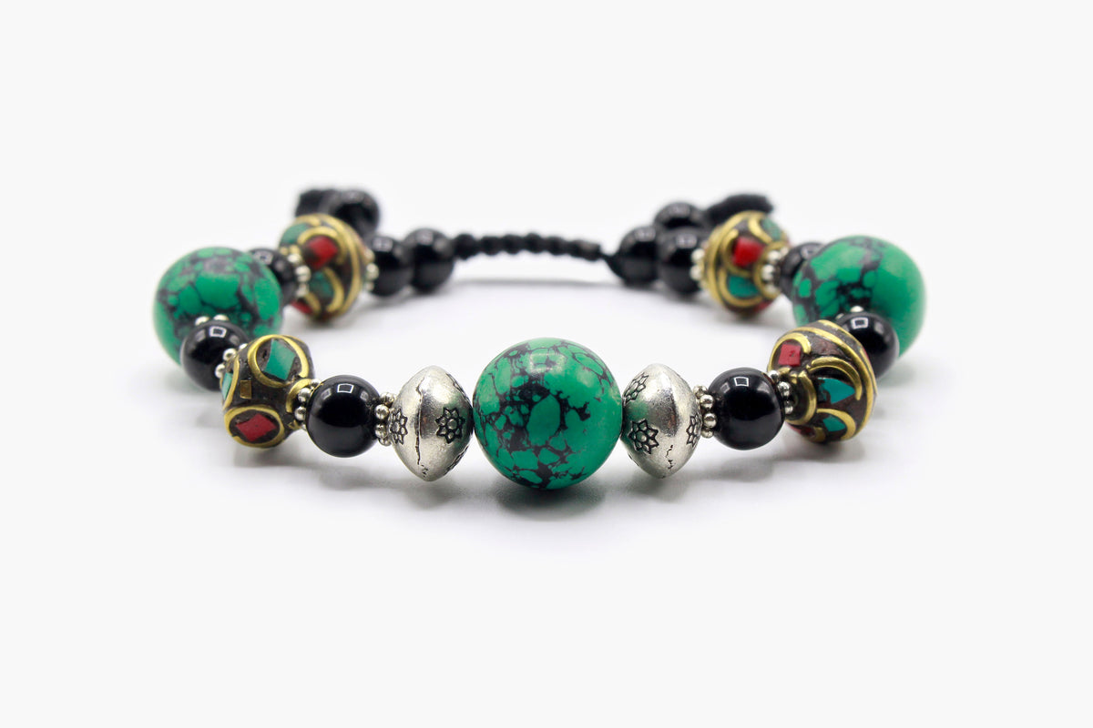 Black Onyx and Turquoise bead bracelet with Tibetan bead details, front view.