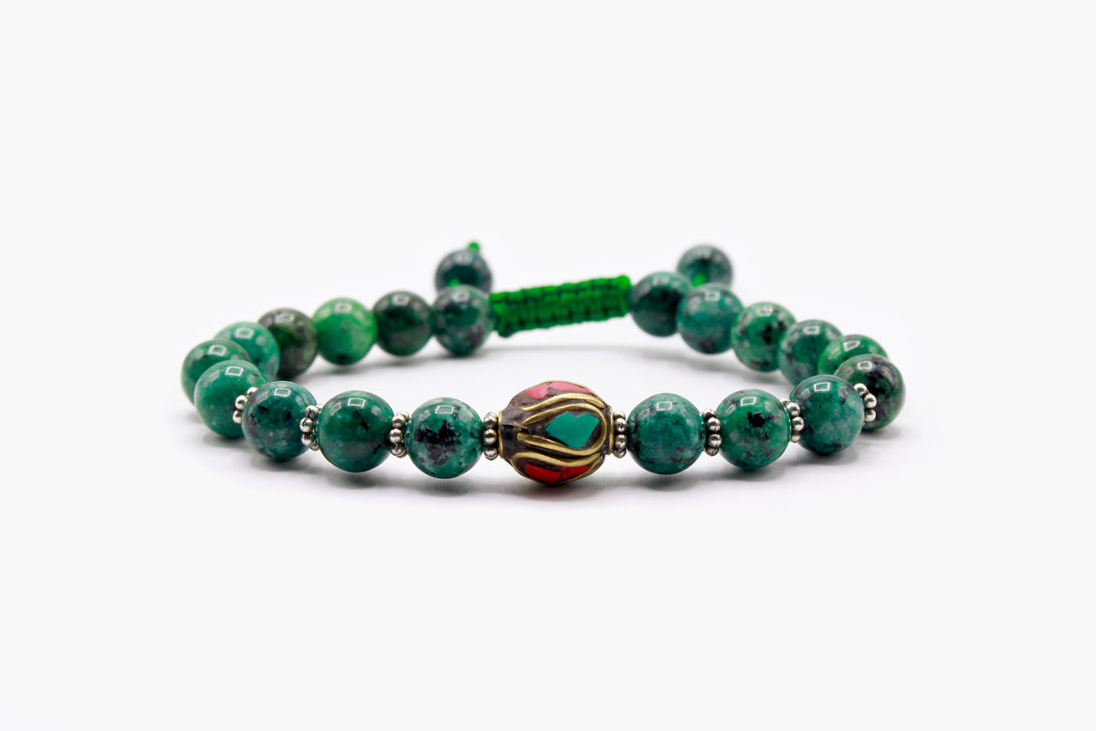 Green Sodalite bead bracelet with central Tibetan bead containing Red Coral and Turquoise accents.