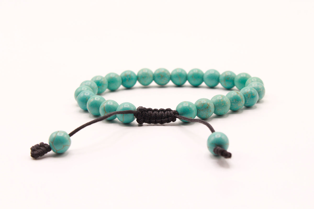 Light turquoise bead bracelet showing the dark adjustable Cobra Knot closure and pull ends.