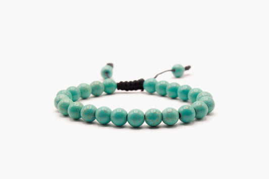 Light turquoise 8 mm bead bracelet with subtle tan-brown markings, front view.