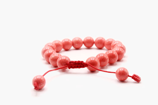 Pink Coral bead bracelet showing the adjustable red Cobra Knot closure.