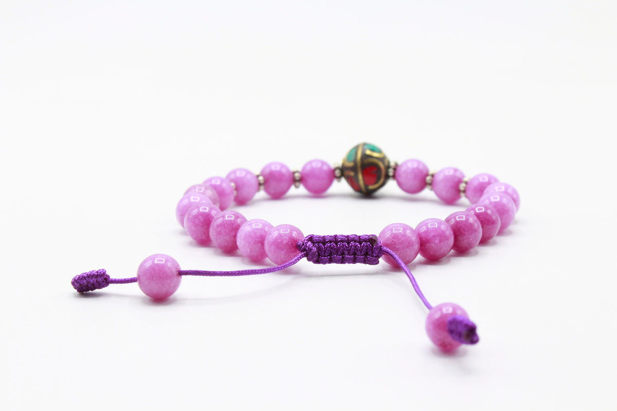 Rose Quartz bead bracelet showing the purple adjustable Cobra Knot closure.