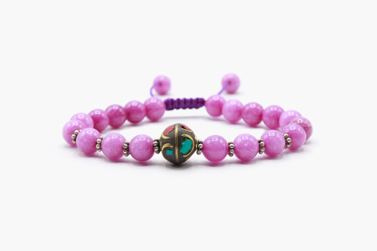 Pink Rose Quartz bead bracelet with a central multicolor Tibetan bead, front view.