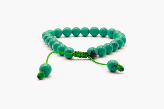 Turquoise bead bracelet showing the adjustable Cobra Knot closure and pull ends.
