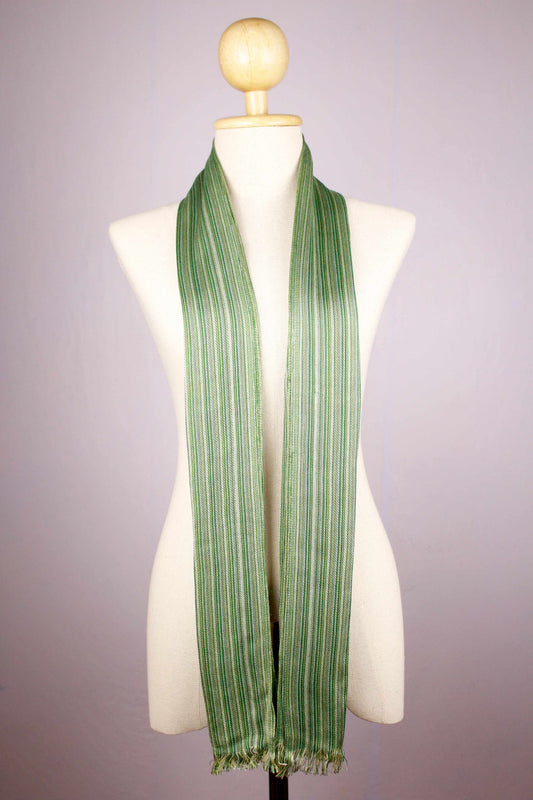Women's 100% bamboo shades of green striped scarf draped on a mannequin, showing the full length and micro-fringed ends