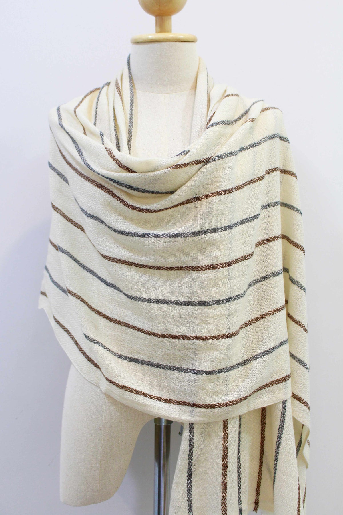 Women's 100% cashmere brown and gray striped beige scarf body wrapped on a mannequin