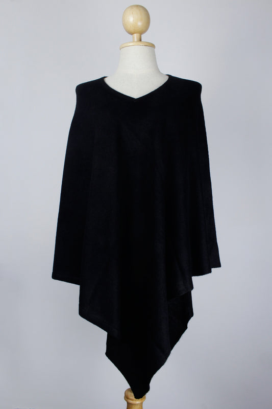 Women's black cashmere V-neck poncho displayed on a mannequin, front view.