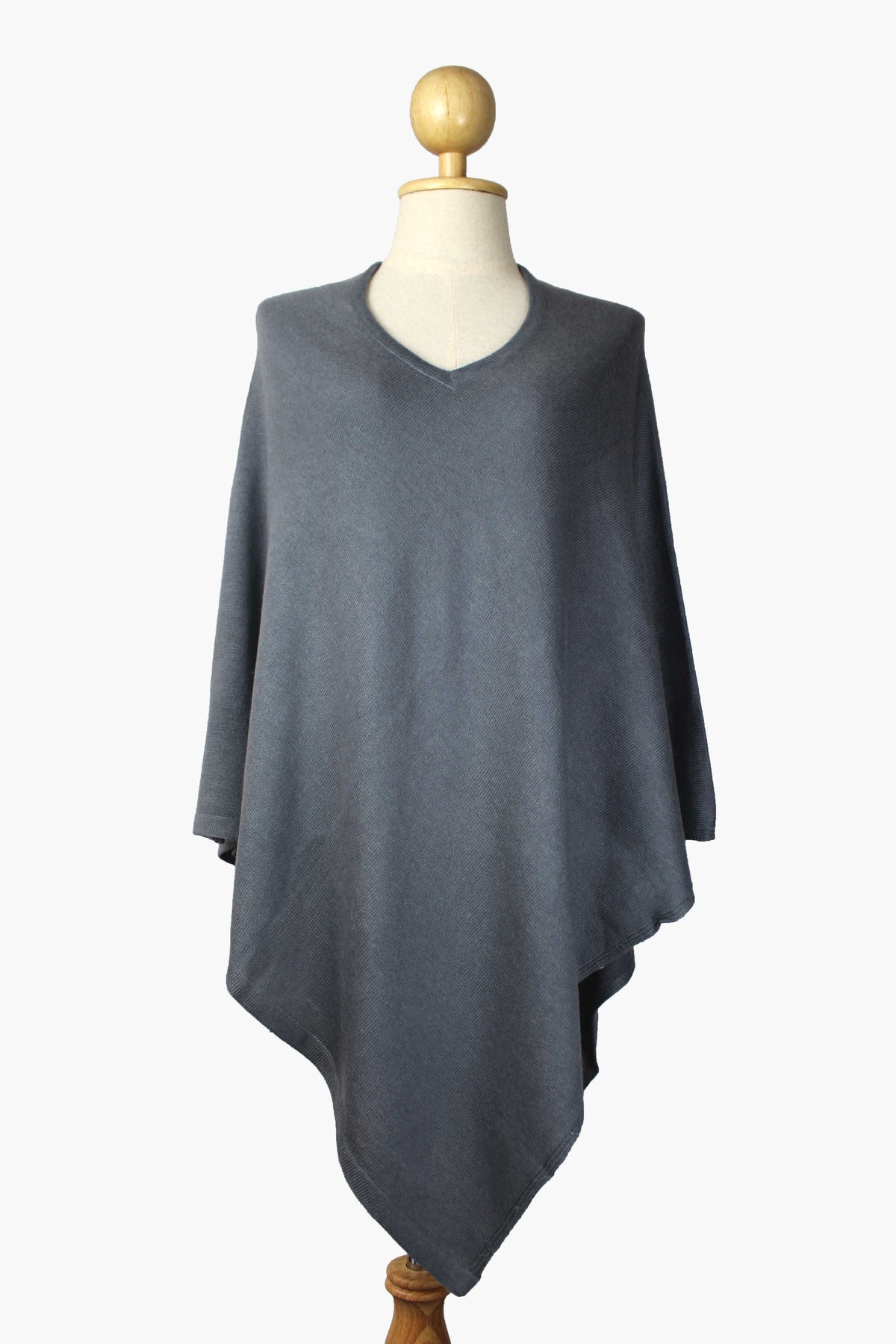 Women's slate gray cashmere V-neck poncho displayed on a mannequin against a white background.