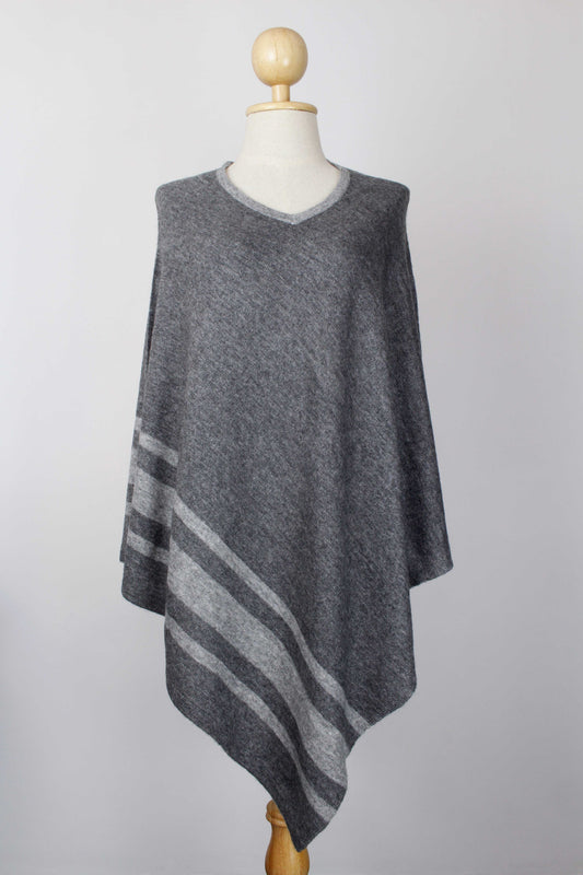 Women's dark gray cashmere V-neck poncho with Silver Gray stripe detailing, front view on a mannequin.