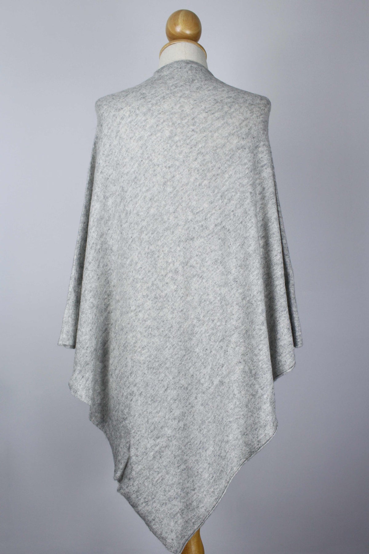 Women's Light Gray cashmere poncho displayed on a mannequin, back view showing the flowing silhouette.