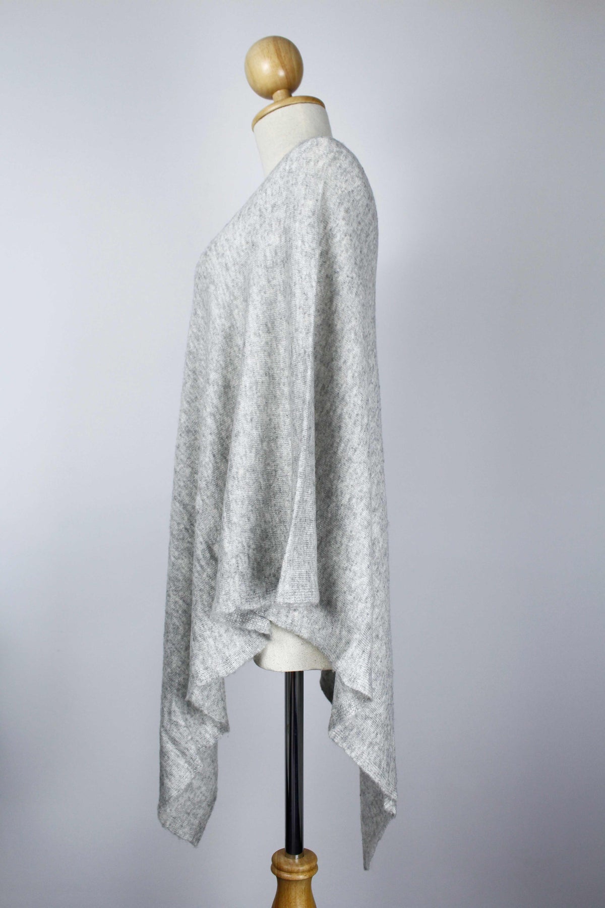 Women's Light Gray cashmere poncho displayed on a mannequin, side view showing the relaxed drape.