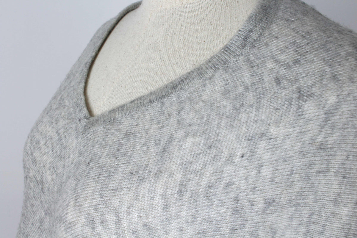 Close-up of the women's Light Gray cashmere poncho showing the V-neckline and fabric texture.