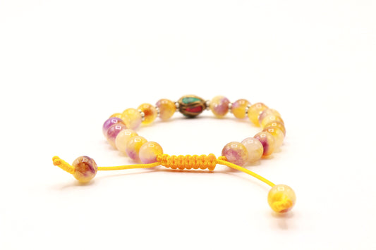 Yellow Jade bead bracelet showing the adjustable yellow Cobra Knot closure.