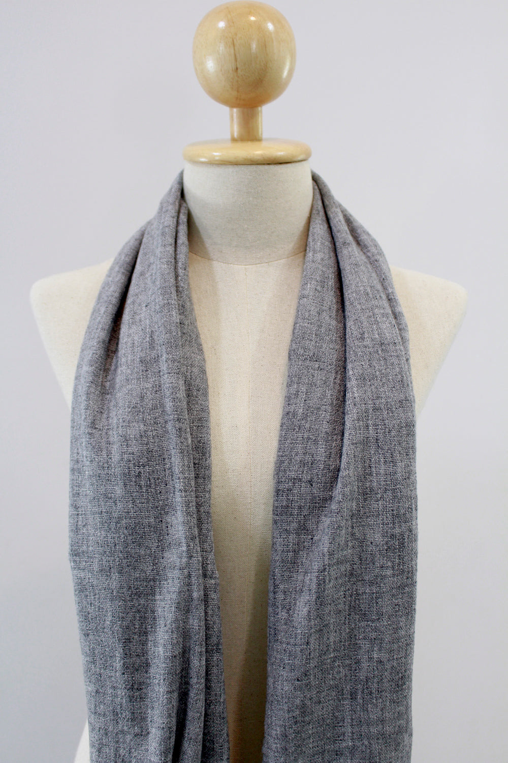 Ash Gray cashmere scarf displayed on a mannequin, draped front view.