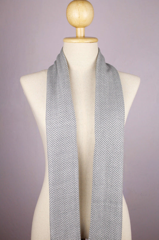 Women's cashmere wool herringbone gray scarf draped around the neck of a mannequin, front view