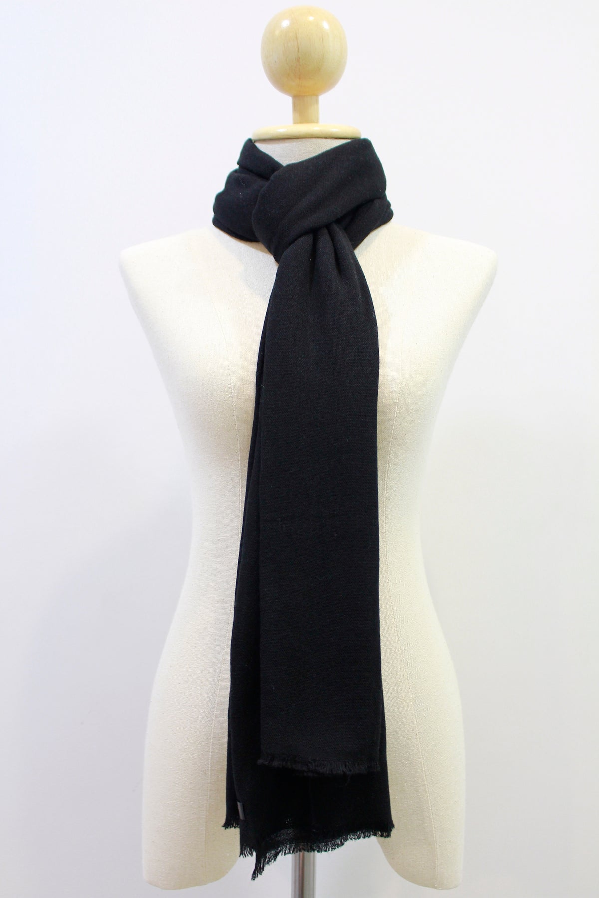Classic Black cashmere scarf looped style display on a mannequin.