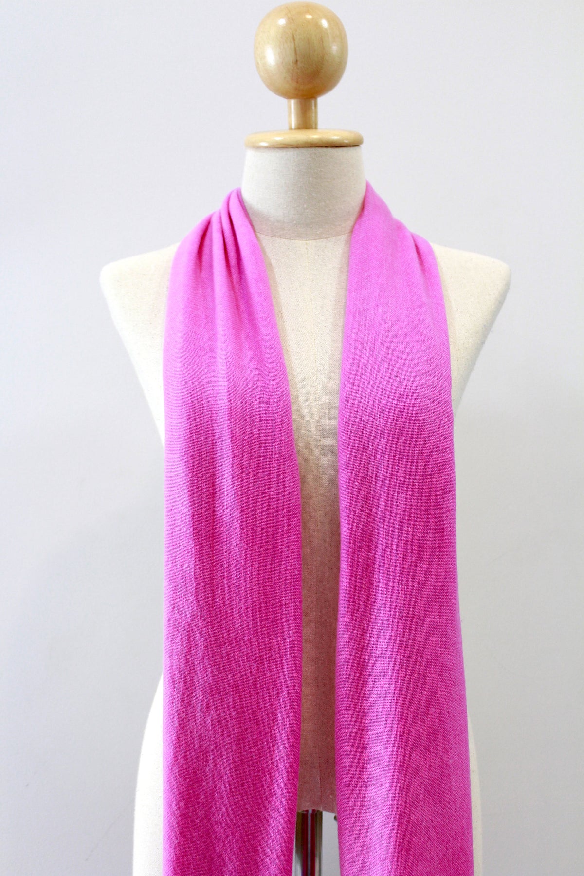 Hot Pink cashmere scarf displayed on a mannequin, front view.