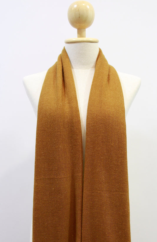 Mustard Yellow cashmere scarf draped on a mannequin, front view.