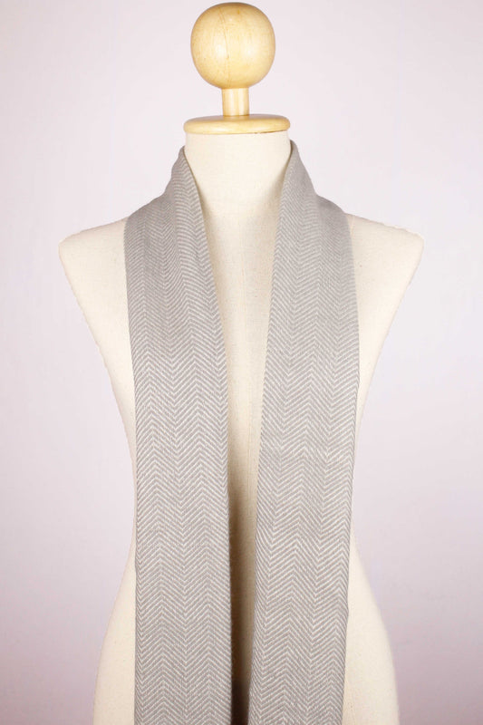 Women's cashmere wool chevron warm gray scarf draped around the neck, front view