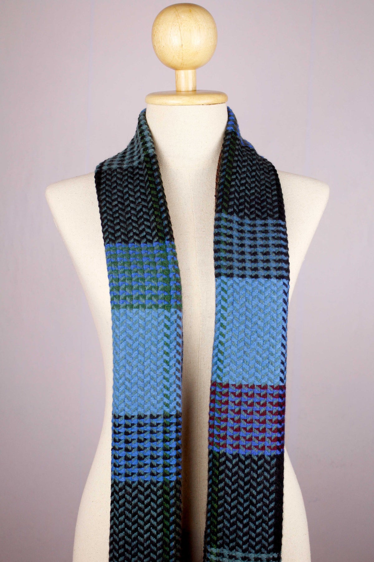 Women's 100% cashmere wool herringbone scarf in shades of blue, draped
