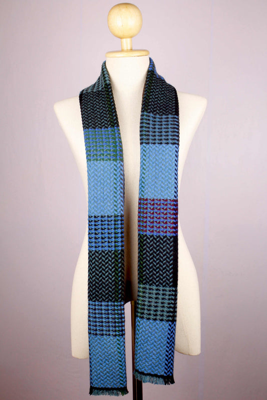Women's 100% cashmere wool herringbone scarf in shades of blue full view, draped on a female mannequin 